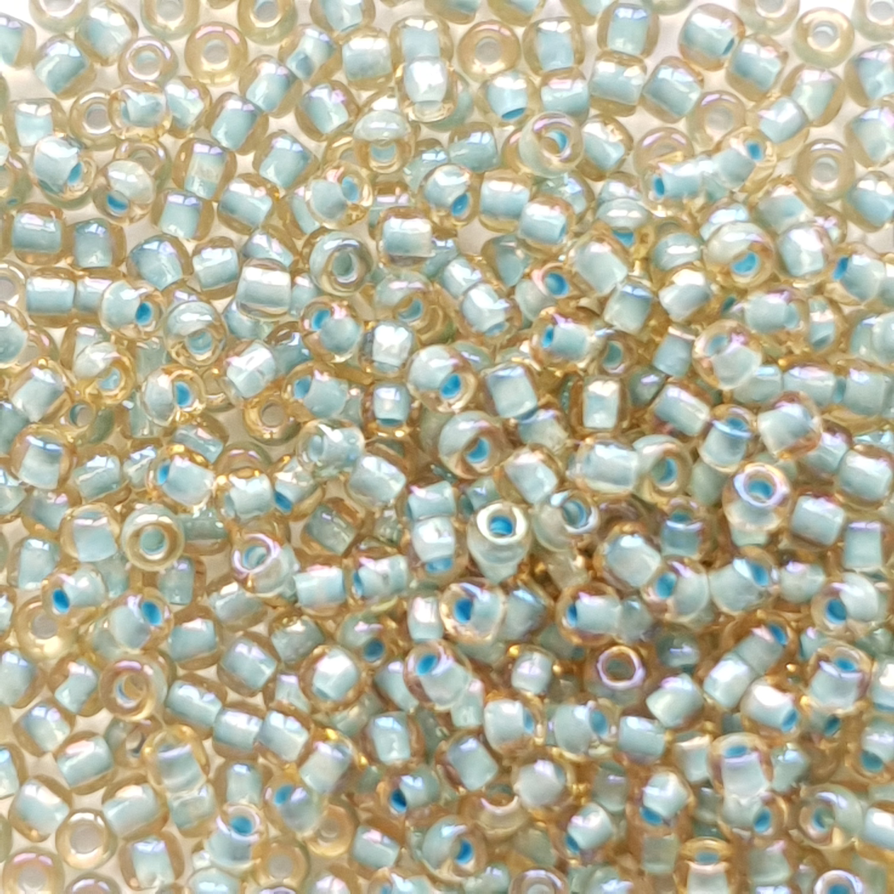 TR-11-952 : TOHO - Round 11/0 : Inside-Color Rainbow Lt Topaz/Sea Foam-Lined